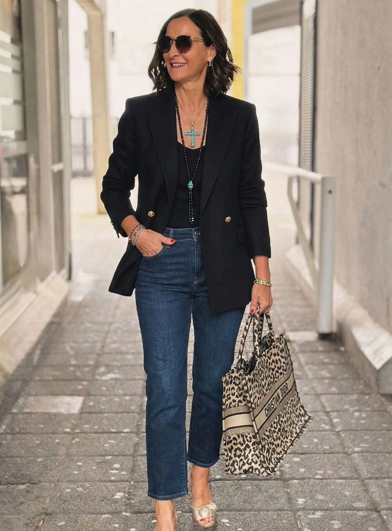 Stylish woman over 40 wearing black blazer and dark jeans for Vanderbilt football game