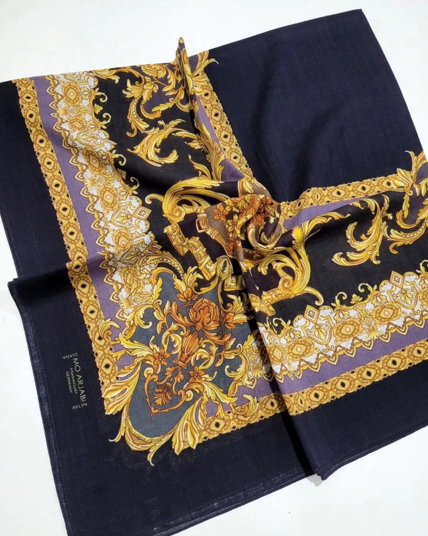 Close-up of a vintage silk scarf with ornate patterns.