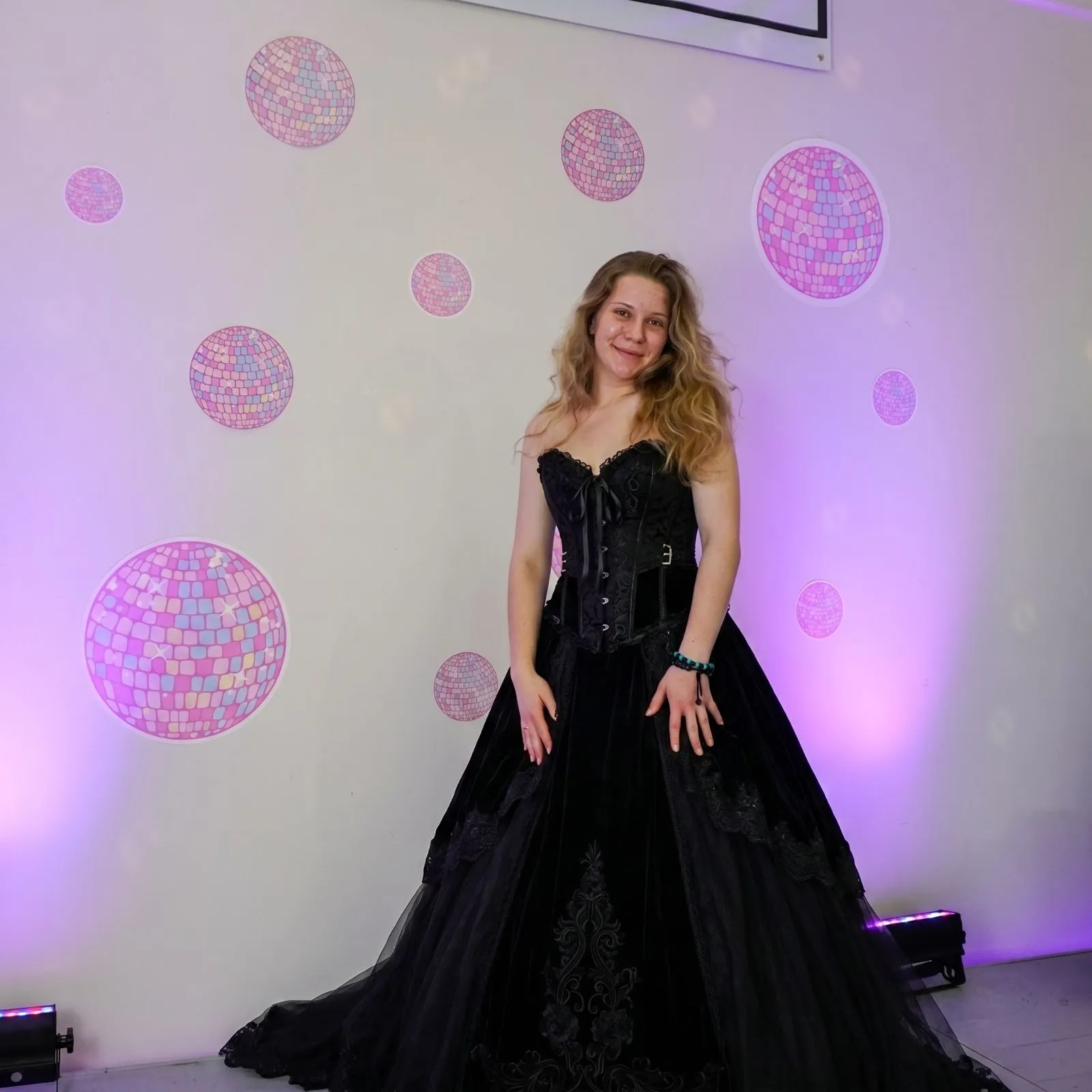 Plus size model wearing a stunning gothic black velvet corset ballgown for a masquerade