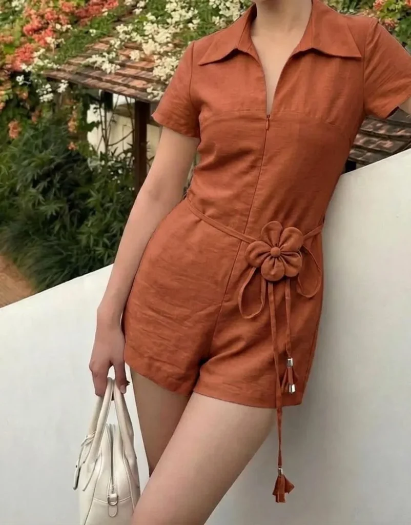 Close up of breathable summer linen romper fabric in rust color