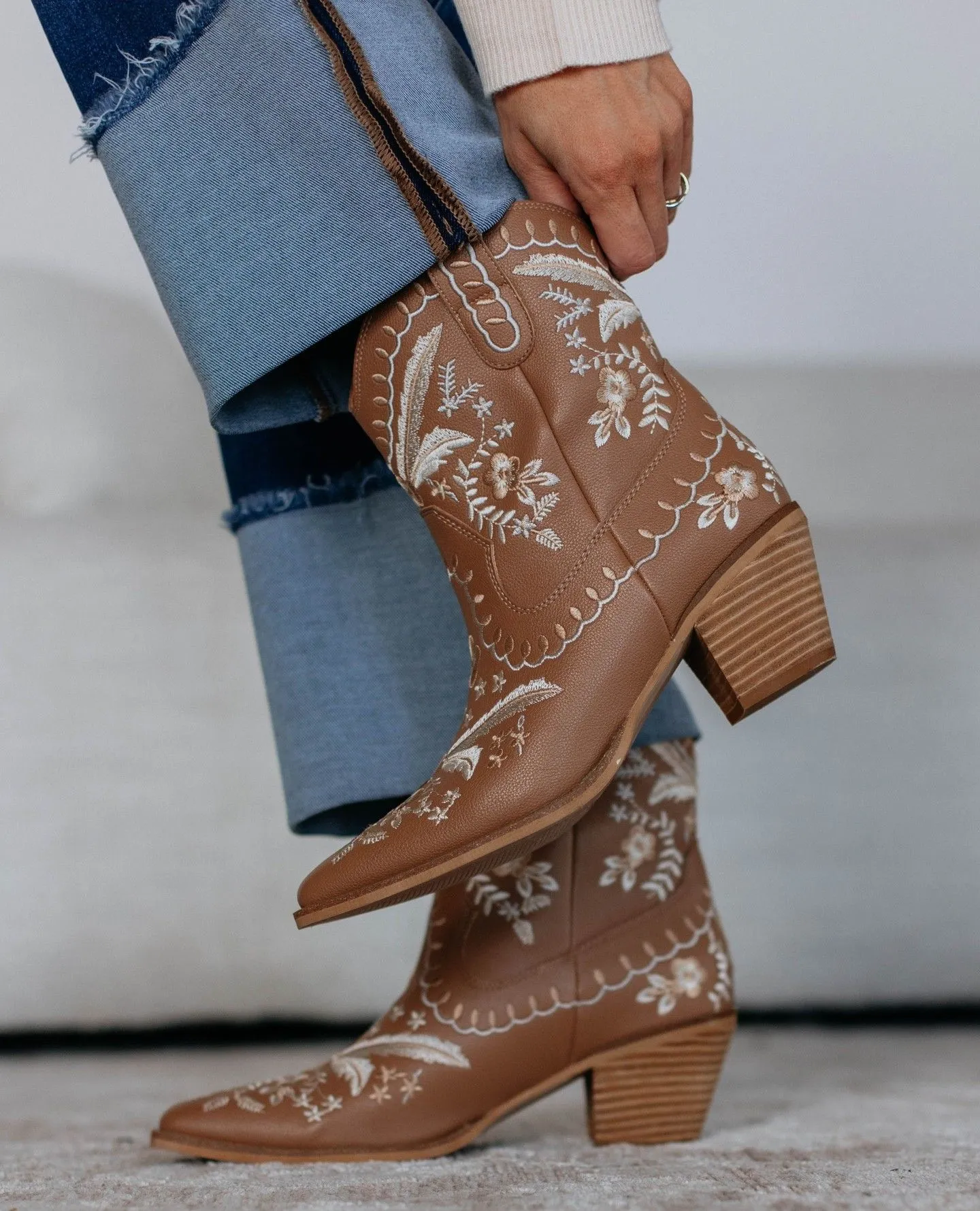 Tan suede cowboy boots with Western stitching