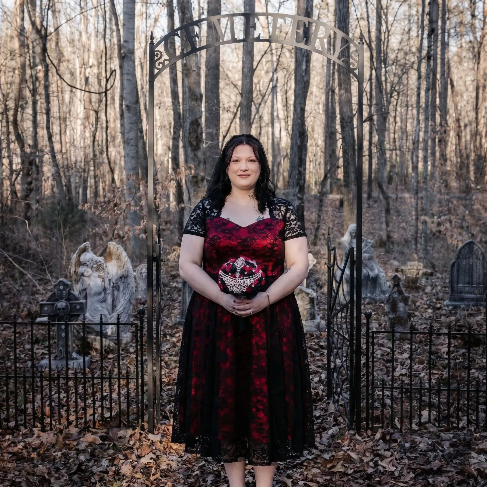 Plus size woman wearing a crimson and black lace midi dress for a gothic masquerade