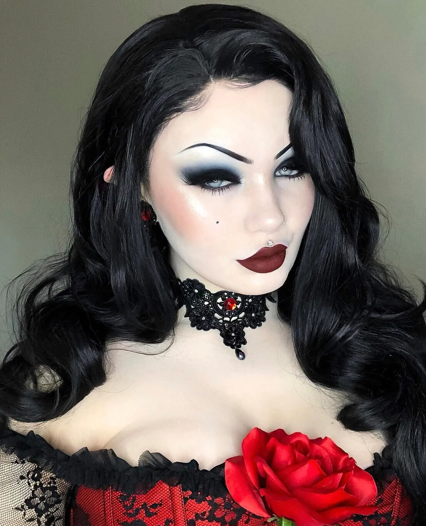 Close up of dark romantic makeup featuring matte burgundy lips and smoky eyes