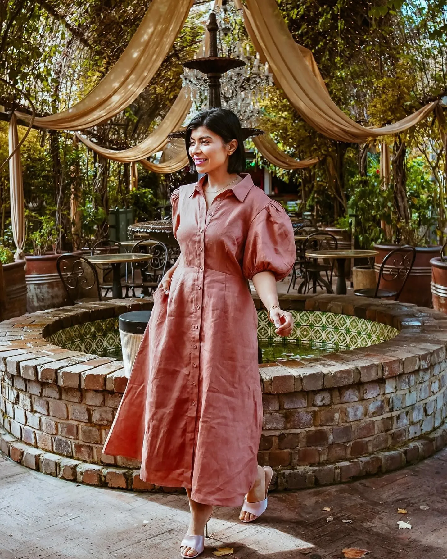 Women wearing classic linen midi dresses outside a Newport mansion