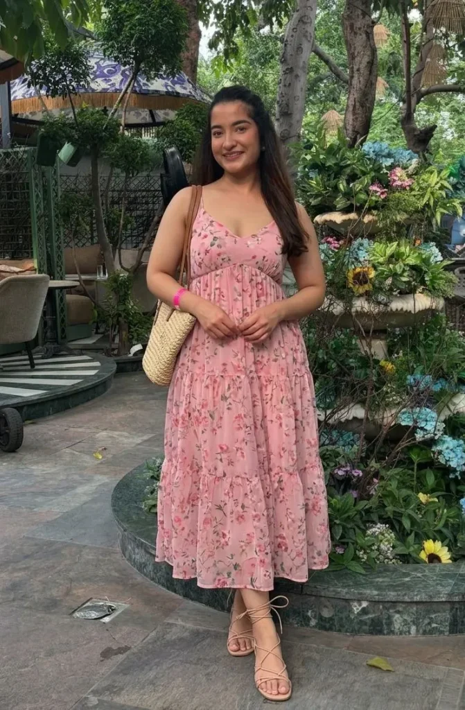 Woman wearing a flowy floral sundress and strappy sandals for a country concert