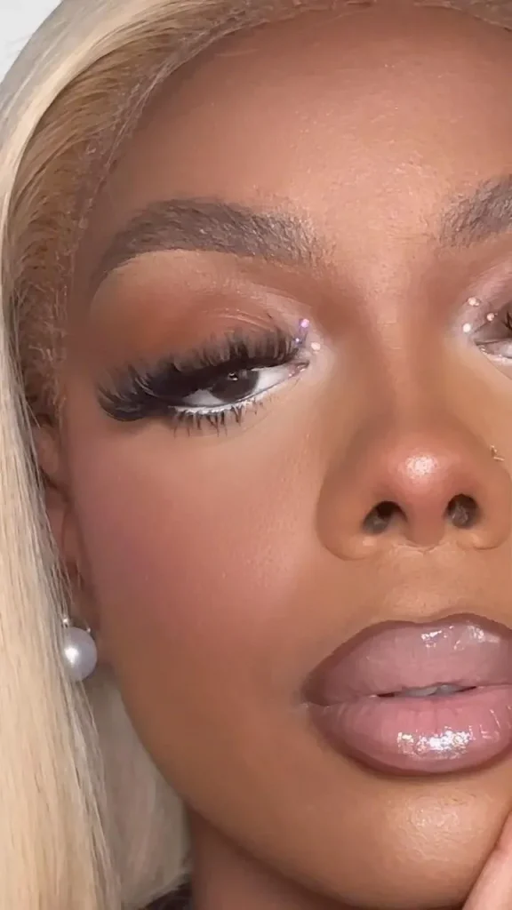 Model with glowy summer makeup and peach blush for a country concert