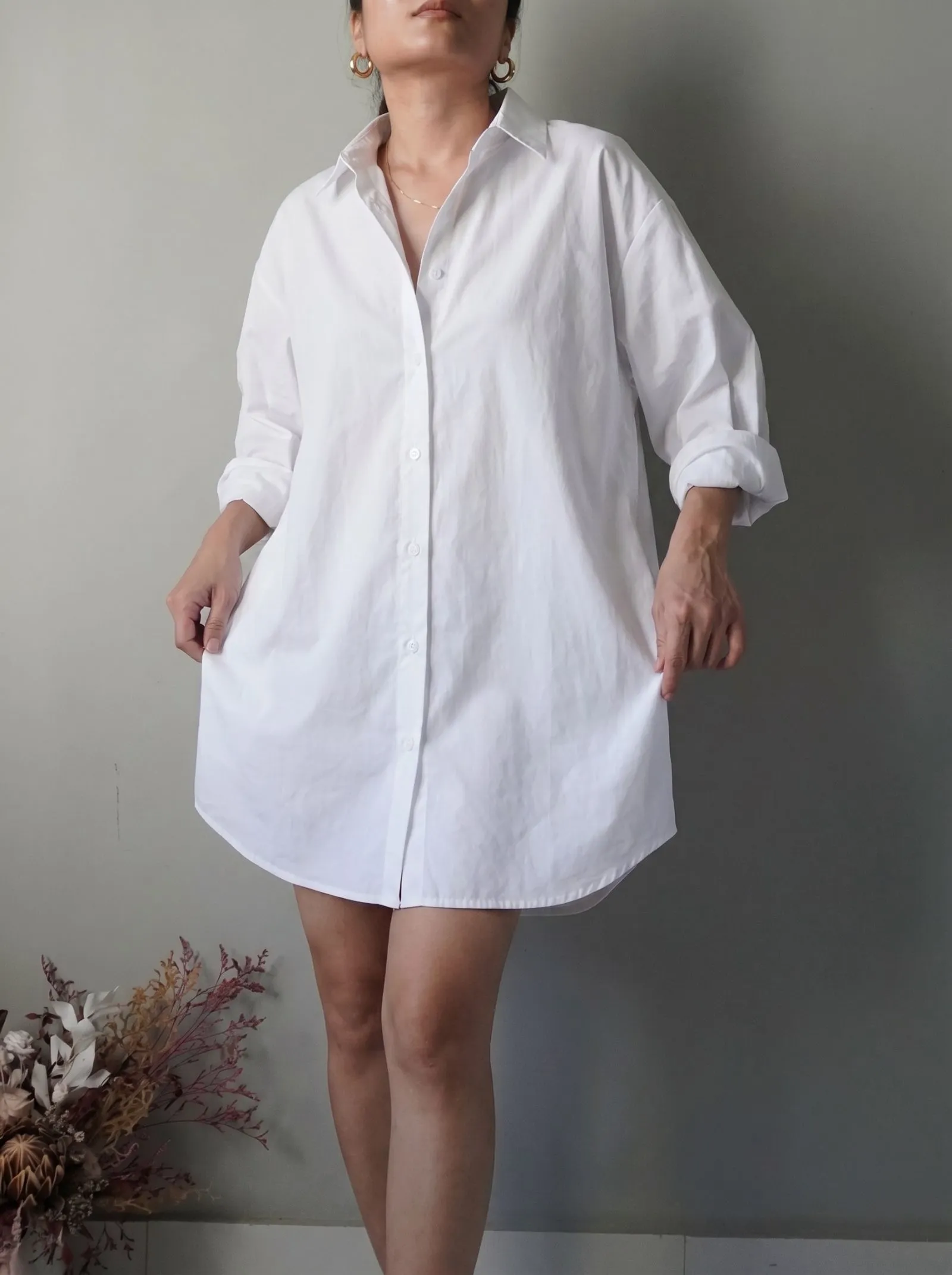 Woman wearing oversized white poplin shirt as a mini dress on NYC streets