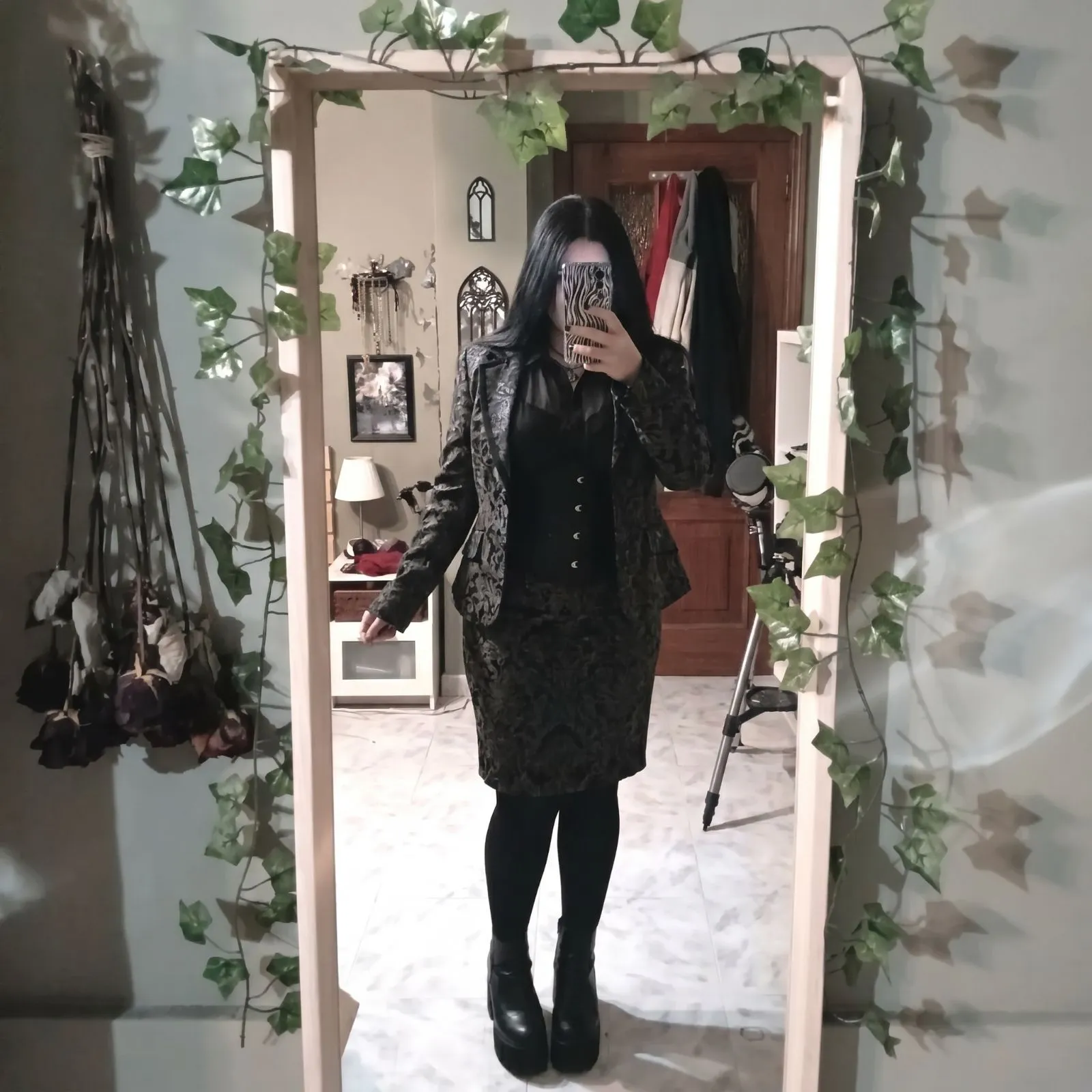 Plus size woman modeling a dark brocade suit and sheer chiffon blouse for a gothic masquerade event