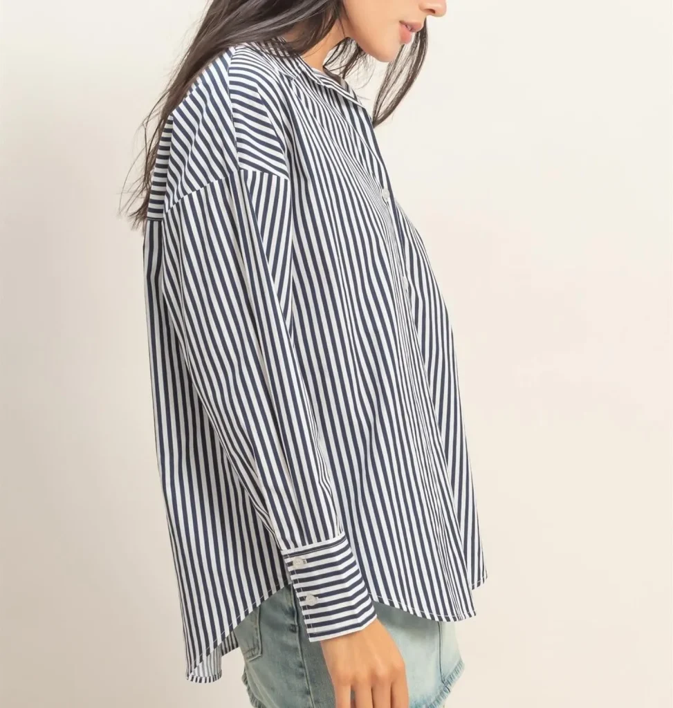 Woman styling a striped short-sleeve poplin shirt over a white tank top
