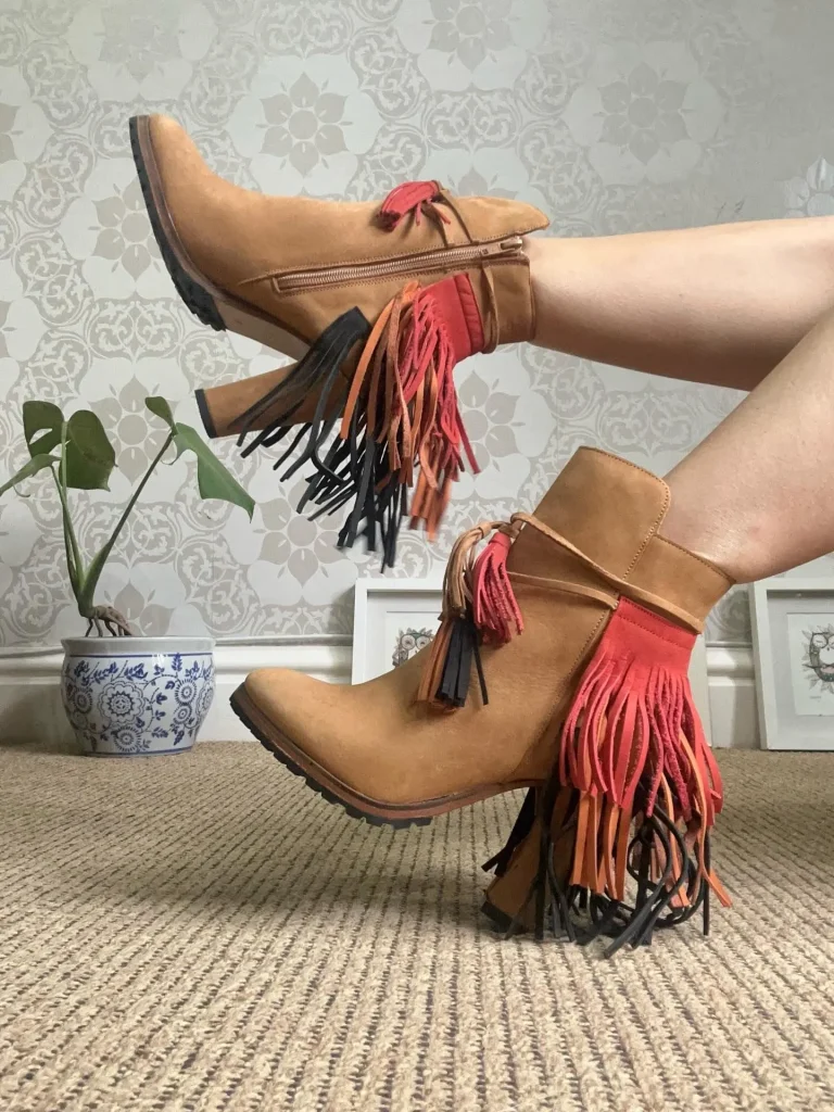 Tan suede ankle booties with fringe styling detail