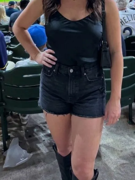 High-waisted denim shorts paired with a silk tank top