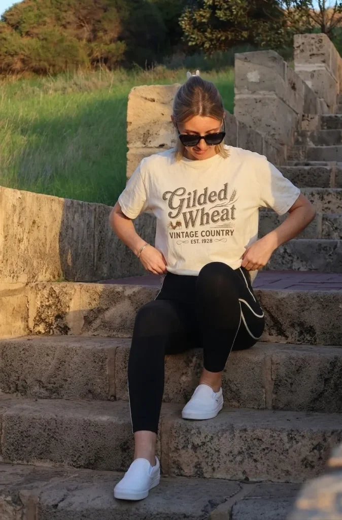Woman wearing a vintage country graphic tee with white slip-on sneakers