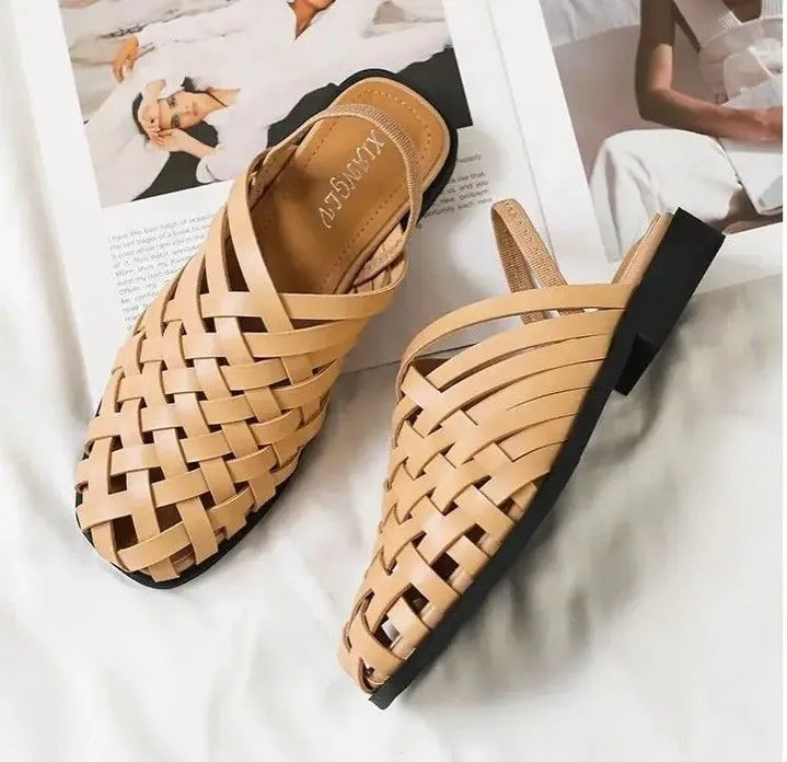 Close up of woven leather slip-on shoes worn with wide leg denim