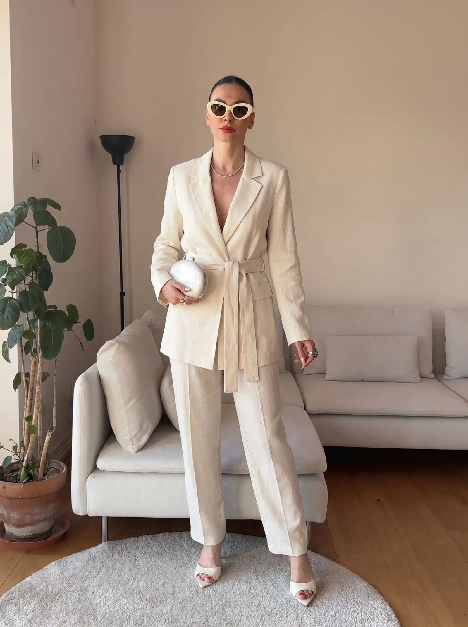 Close up of a belted ivory linen blazer showing fabric texture