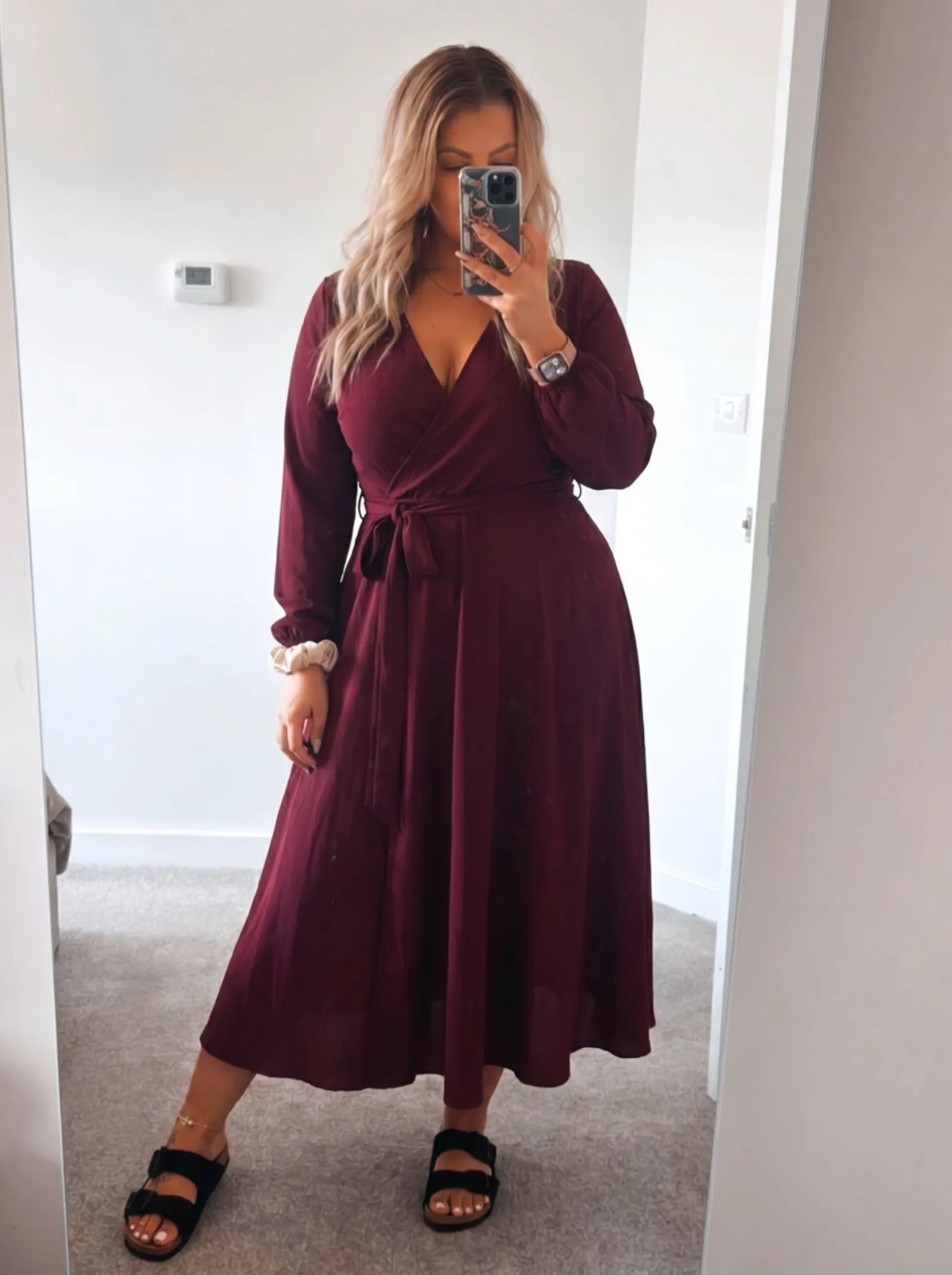 Deep burgundy wrap dress cinched at the waist