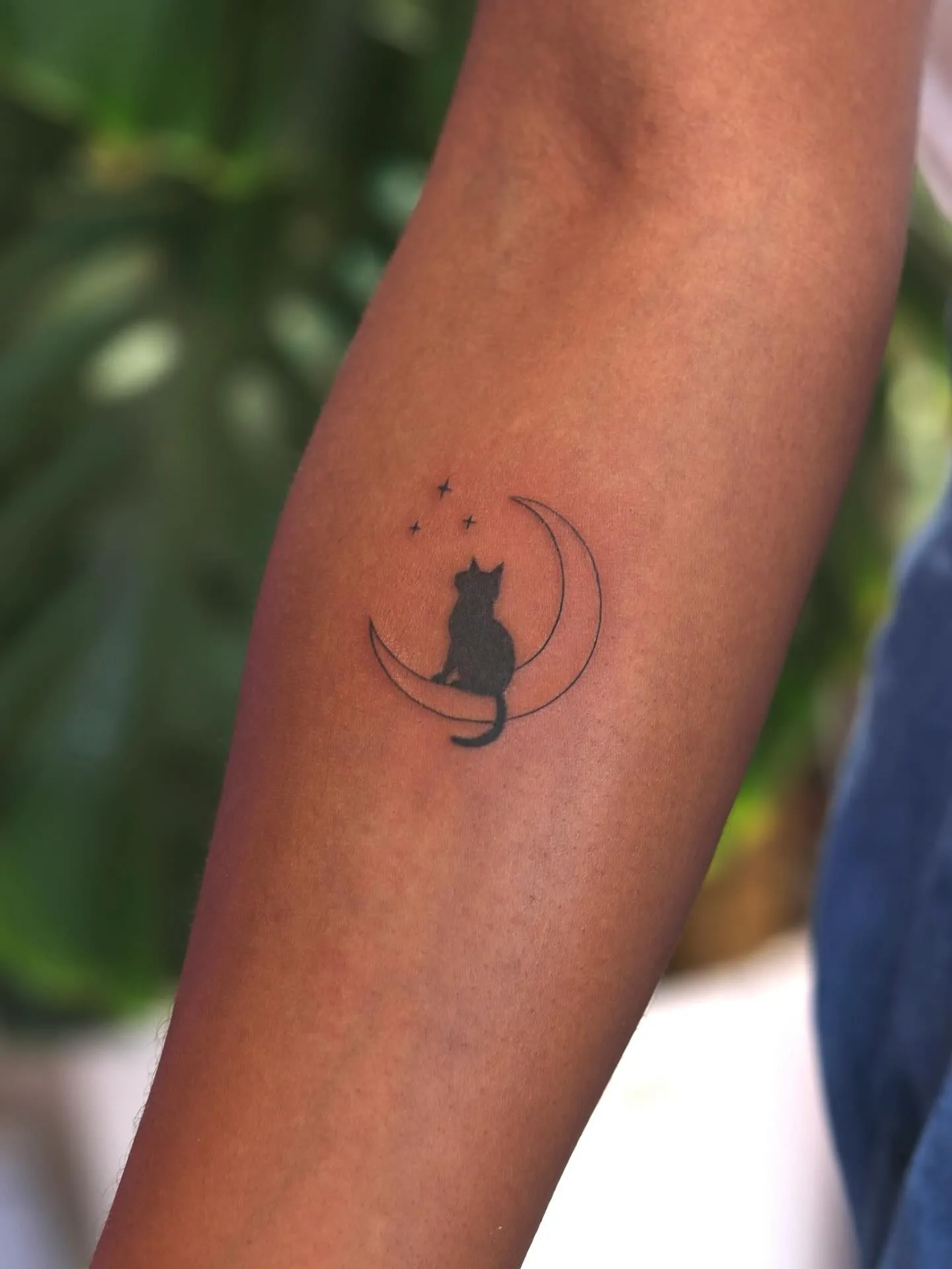 Freshly healed black ink tattoo showing crisp lines on deep skin