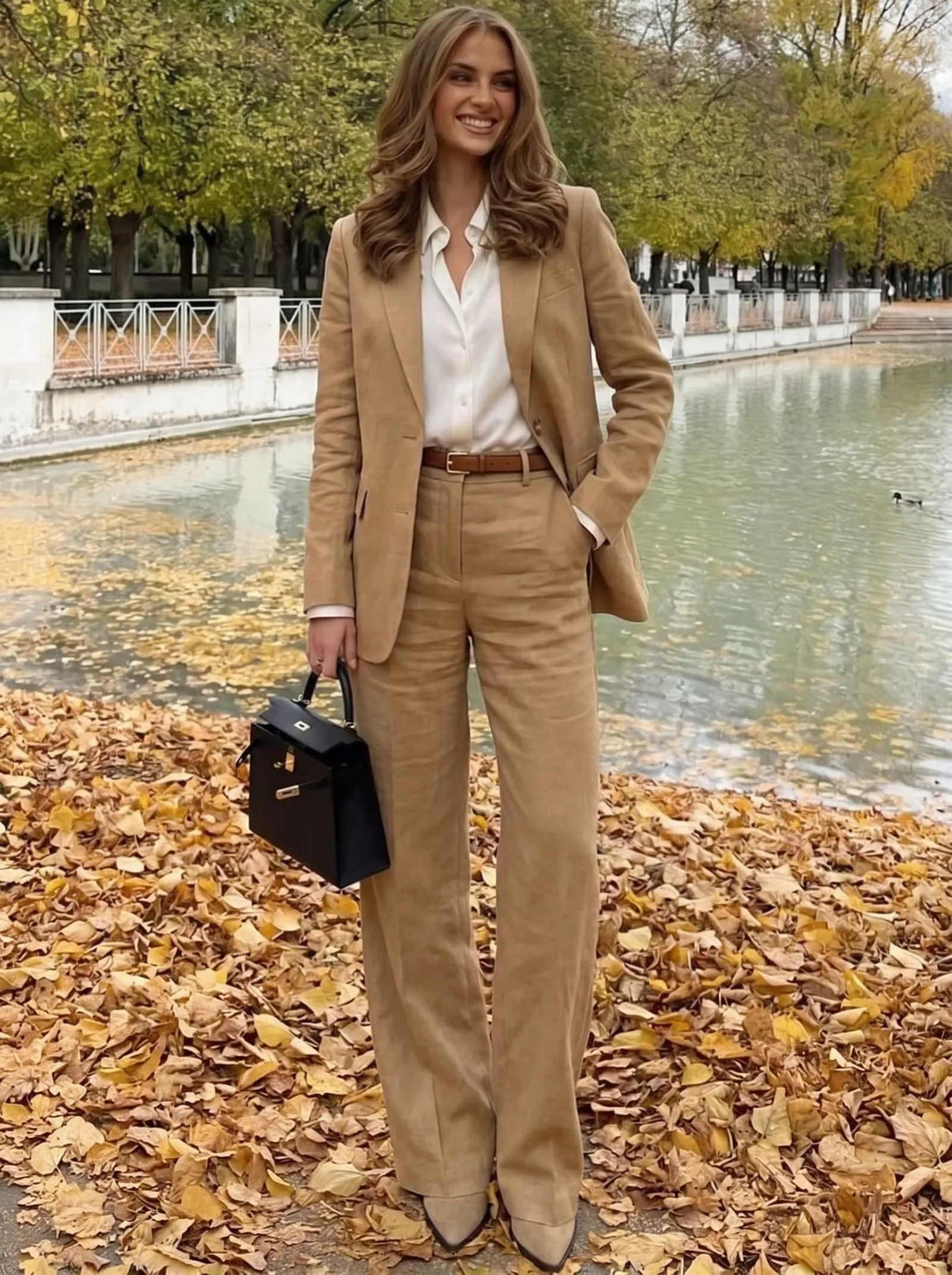 Female executive wearing a high-waisted camel linen pantsuit for summer travel