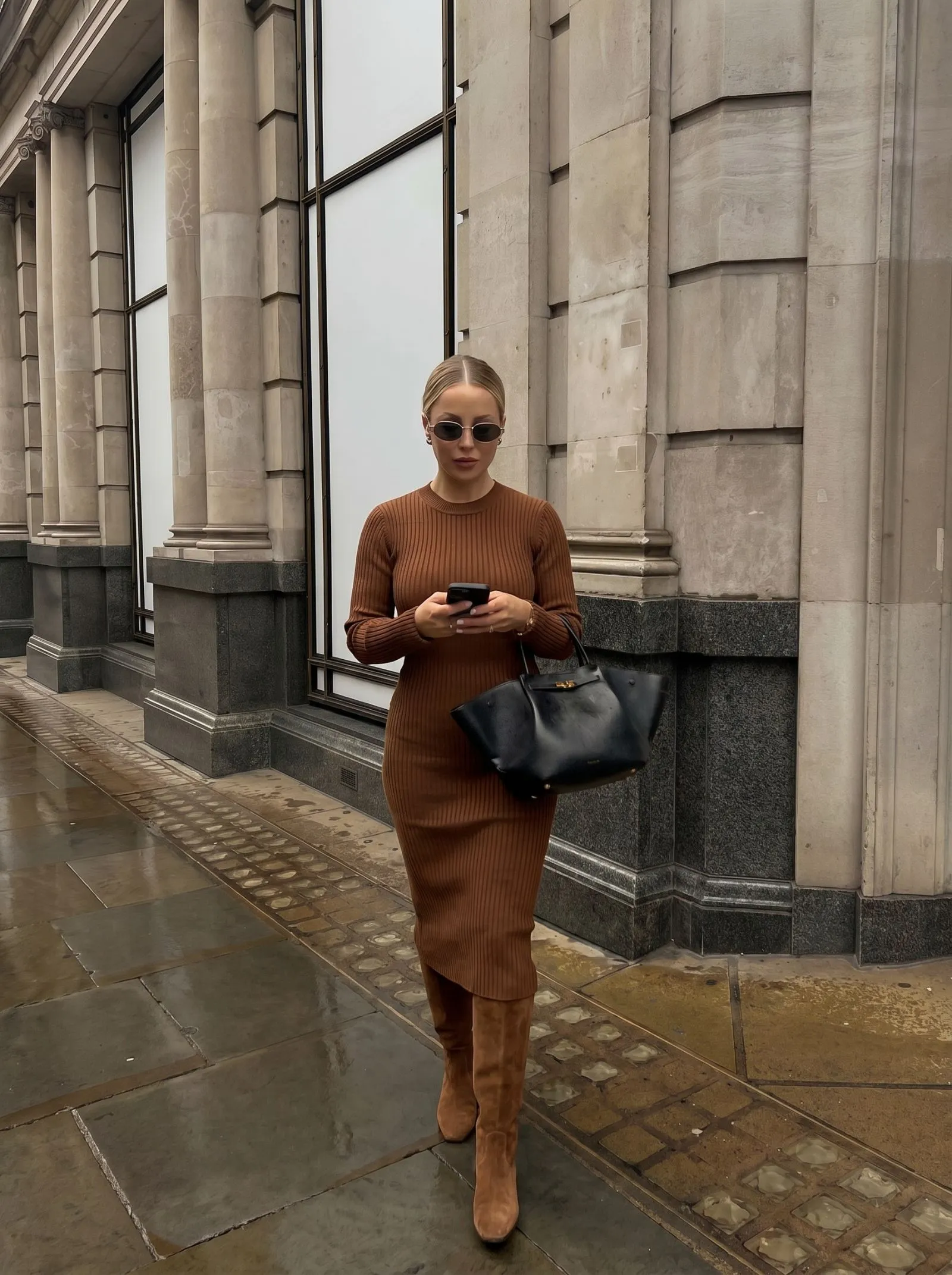 Petite curvy woman wearing a brown ribbed sweater dress and matching suede boots