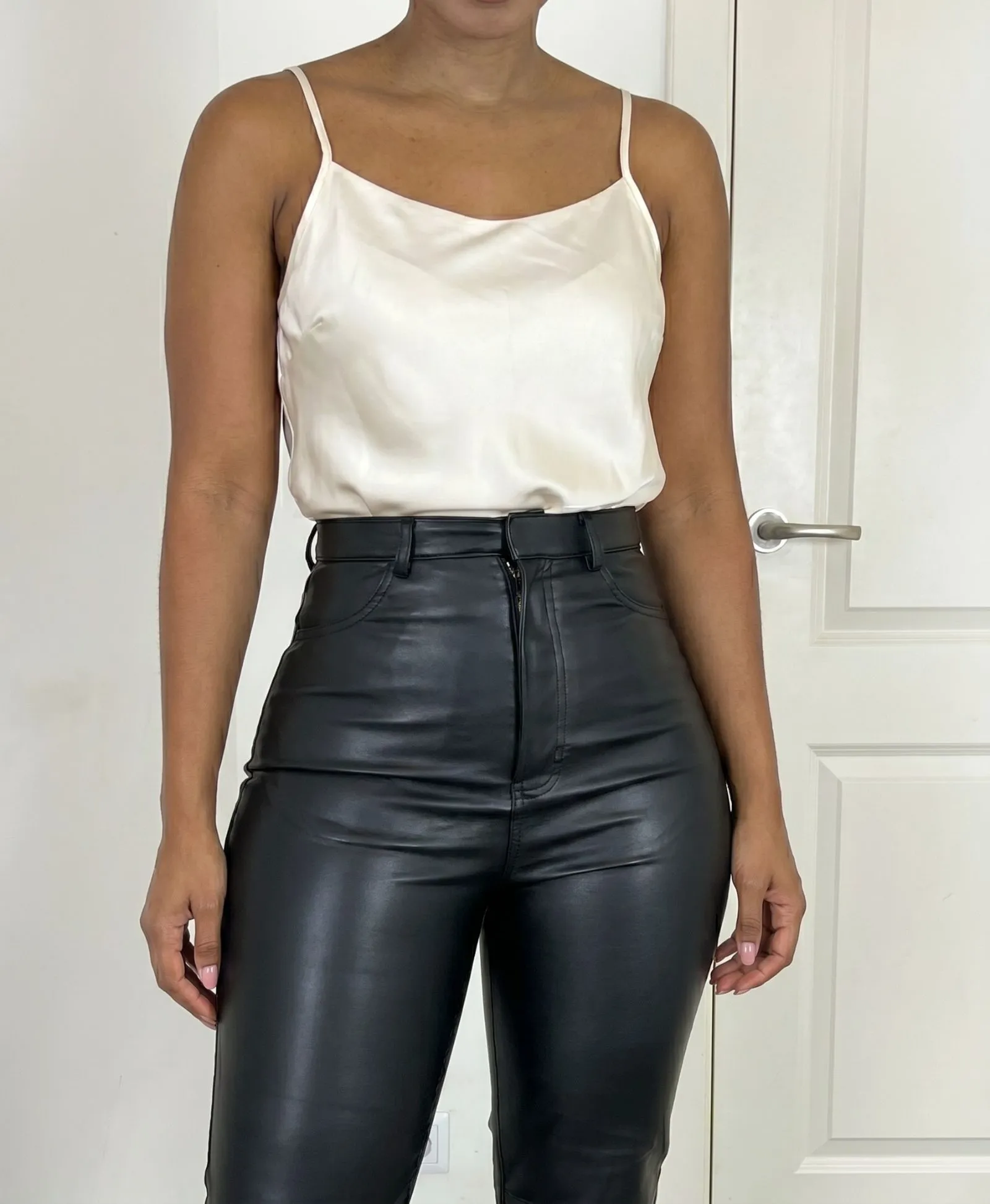 Close up showing silk fabric tucked into tailored leather pants