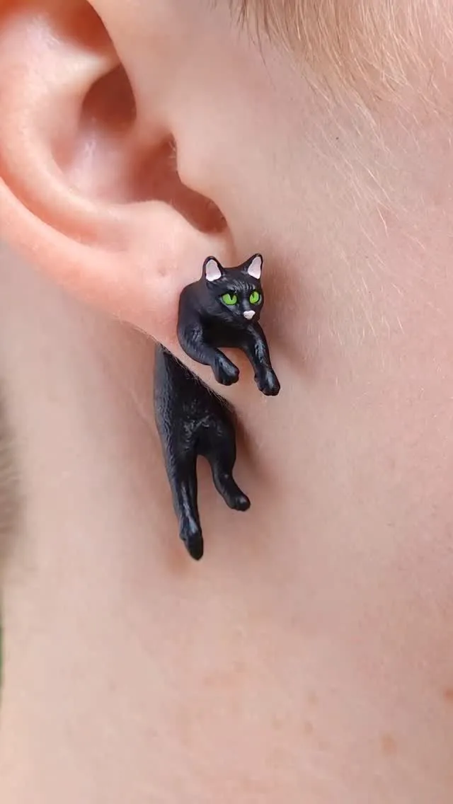 Fine line minimalist black cat silhouette tattoo behind the ear
