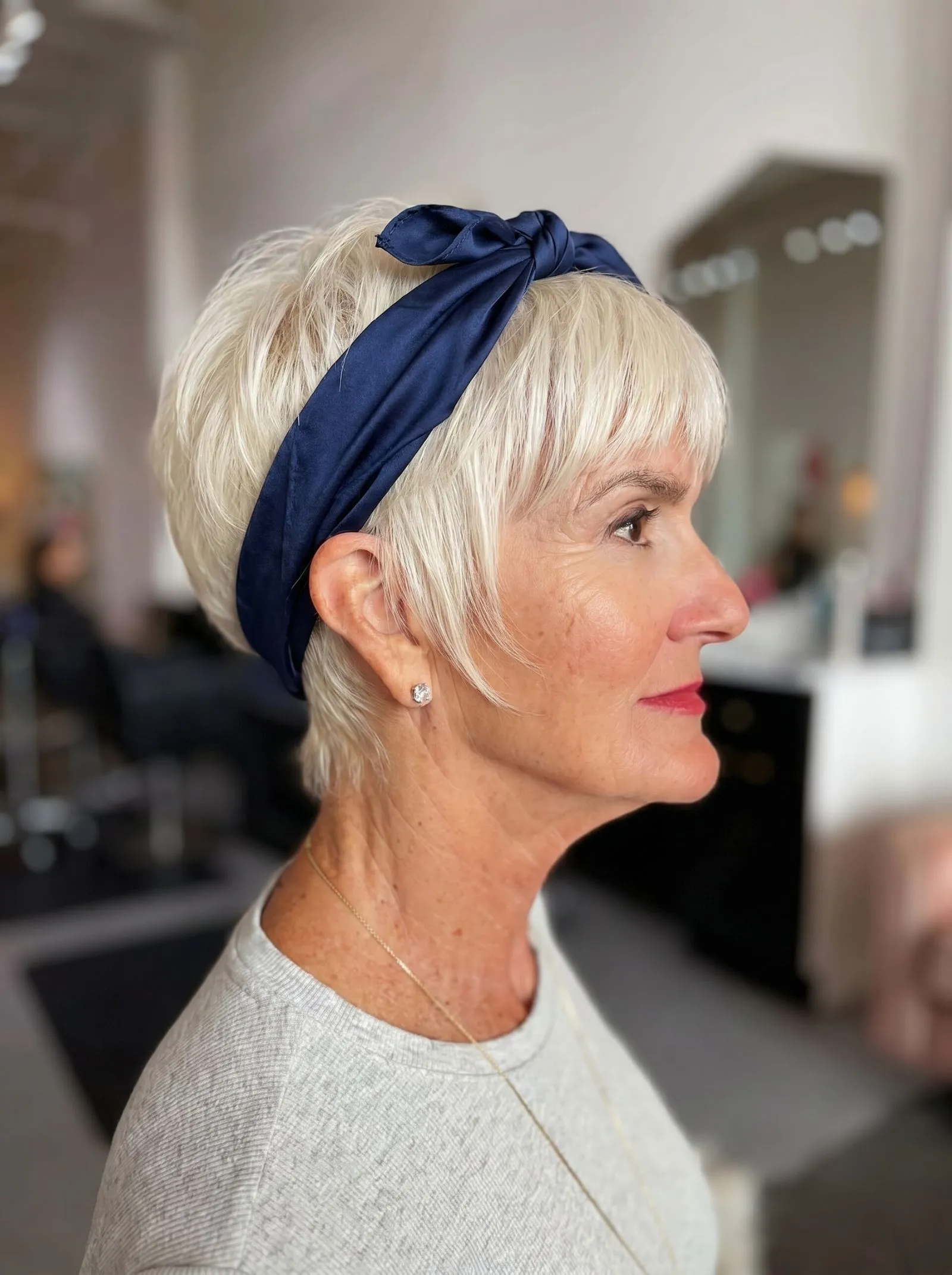 Platinum blonde pixie cut styled with a navy blue silk bandana knot