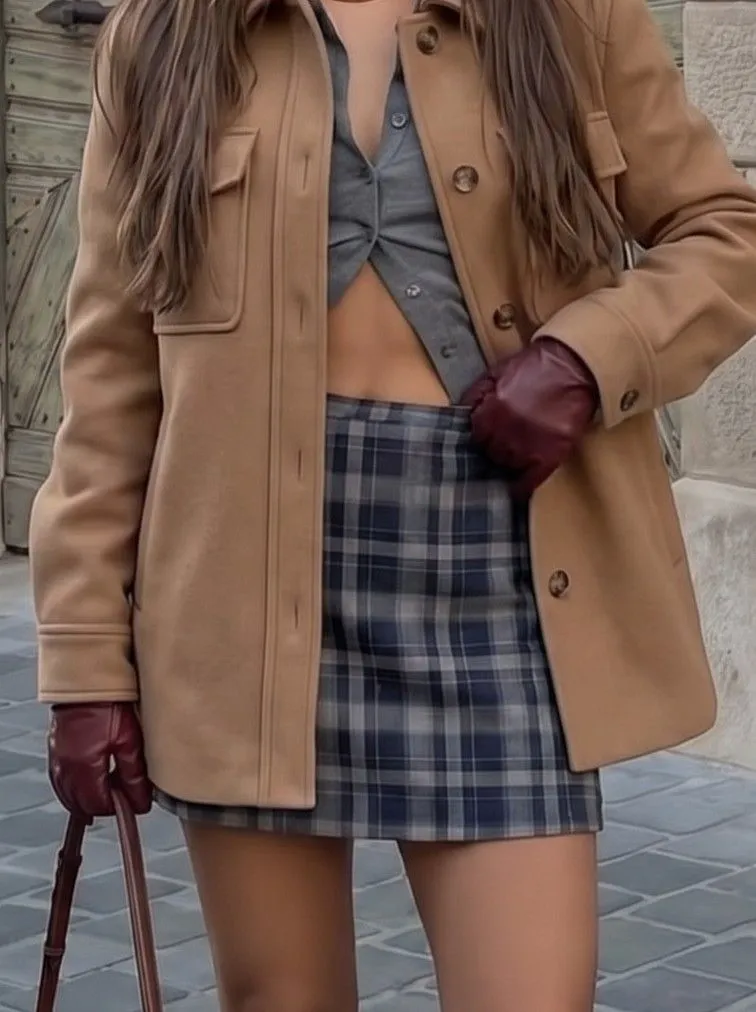 Close up texture of a wool shacket over a ribbed turtleneck and plaid skirt