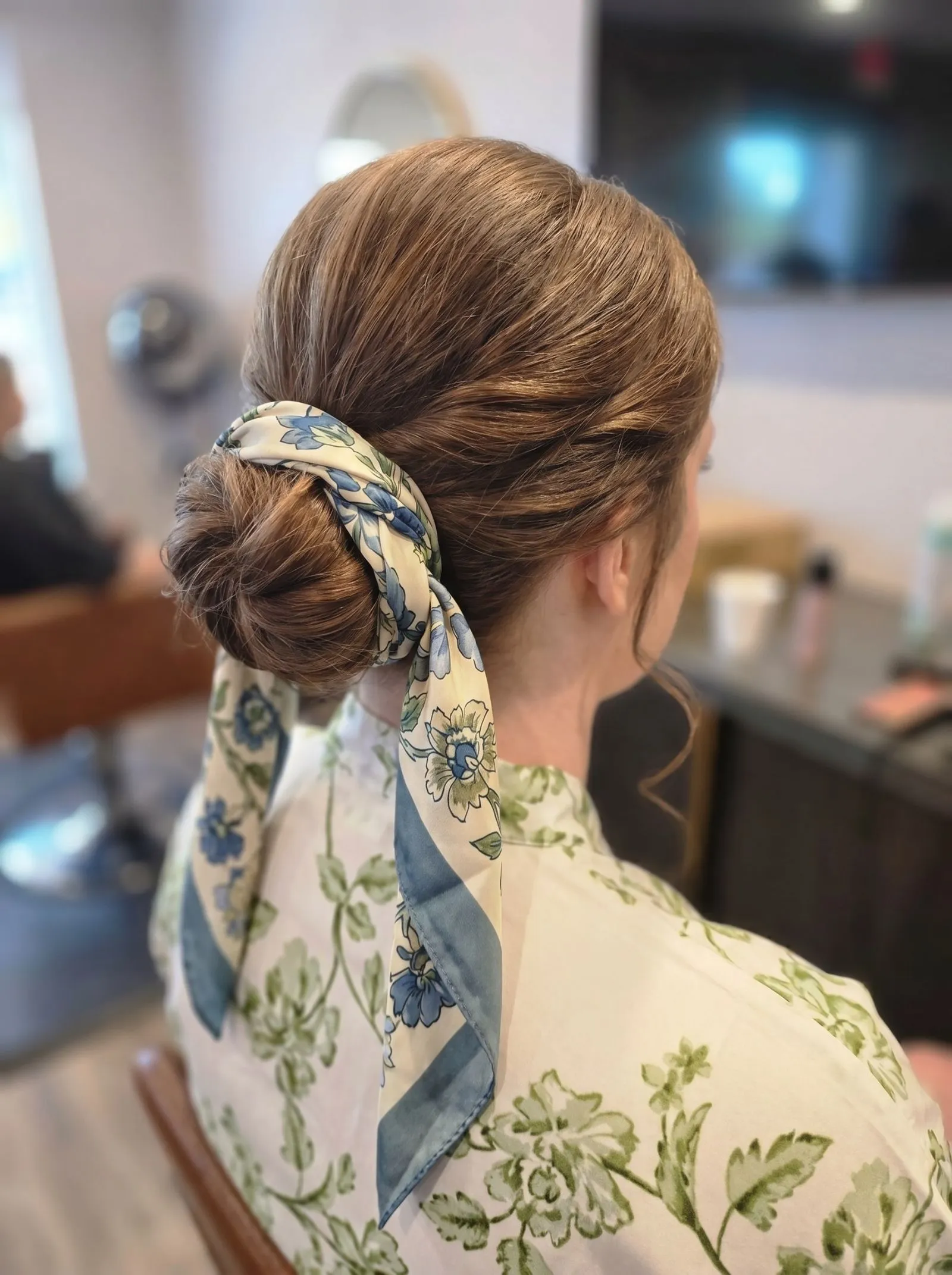 Aesthetic view of a low tucked bun with a fall scarf
