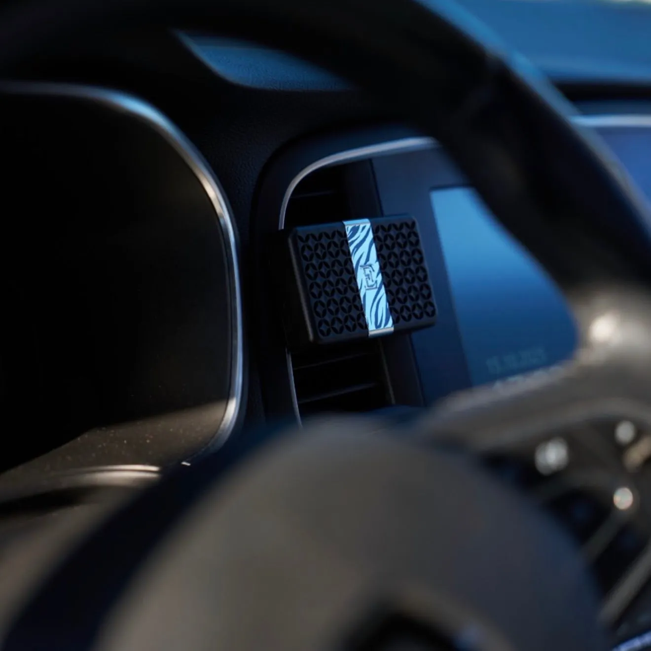 Matte white ceramic car vent diffuser on a clean dashboard