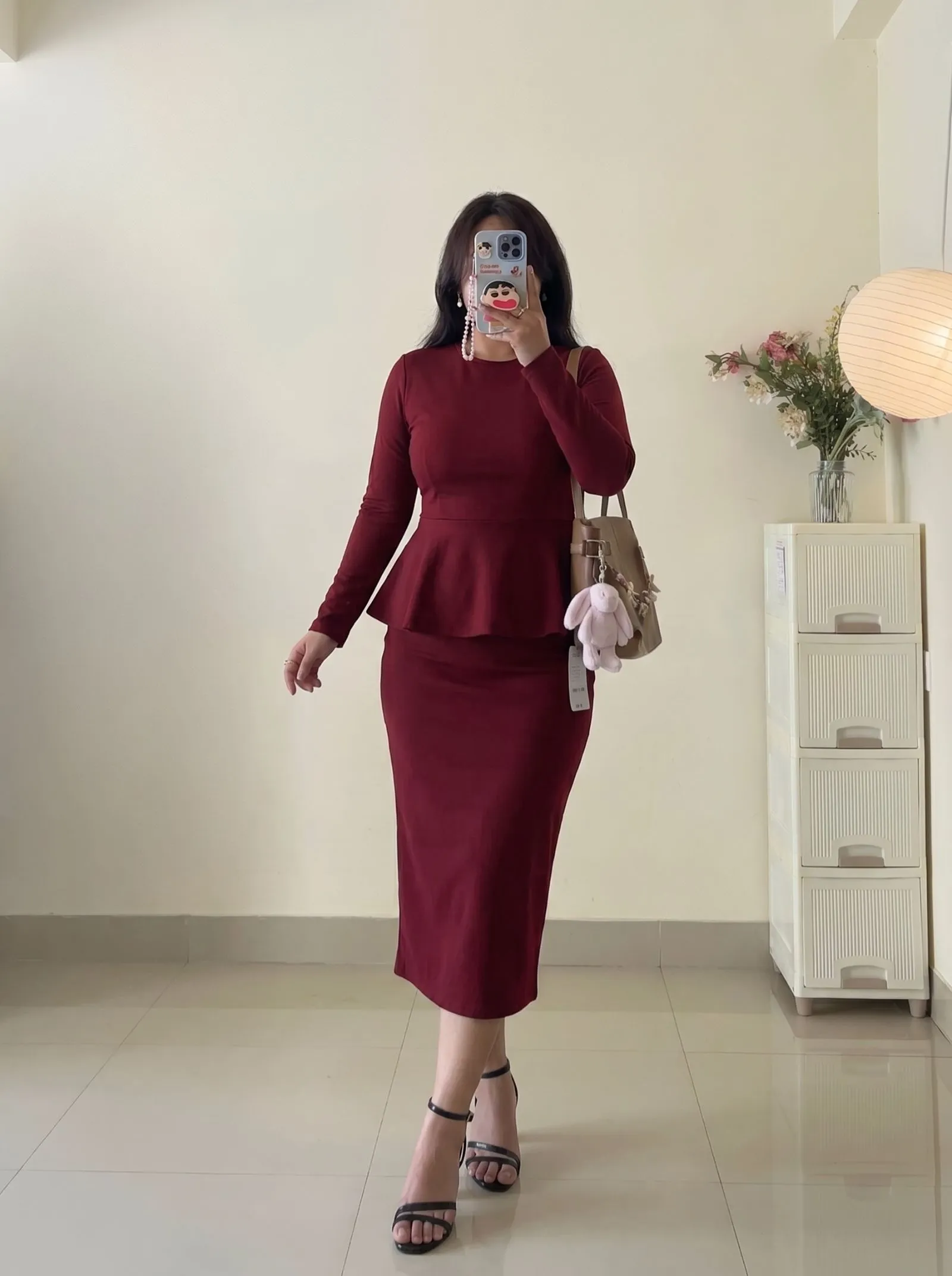 Curvy woman in oxblood peplum top and pencil skirt