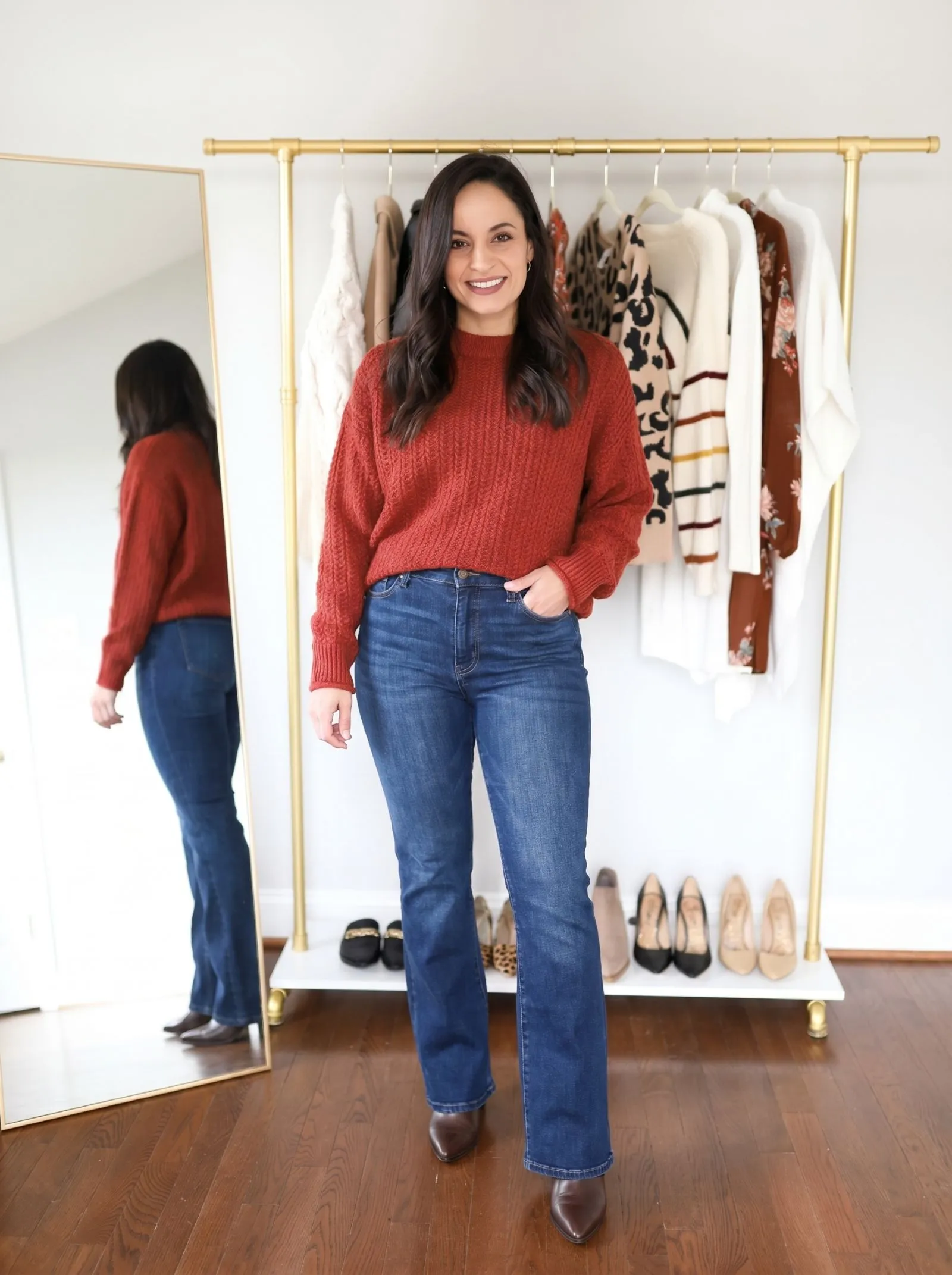 Curvy model wearing dark wash flared jeans and pointed booties for fall