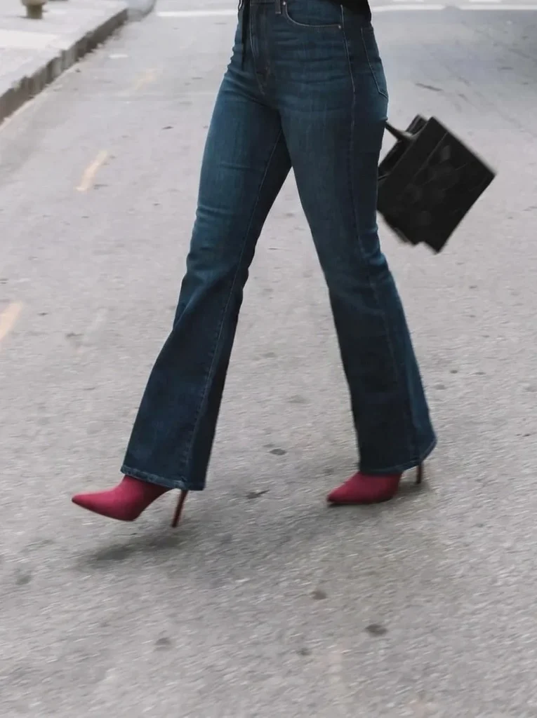 Crimson pointed toe bootie styled with dark wash flared jeans