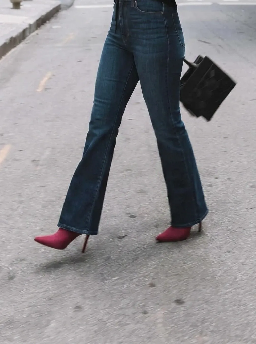 Crimson pointed toe bootie styled with dark wash flared jeans