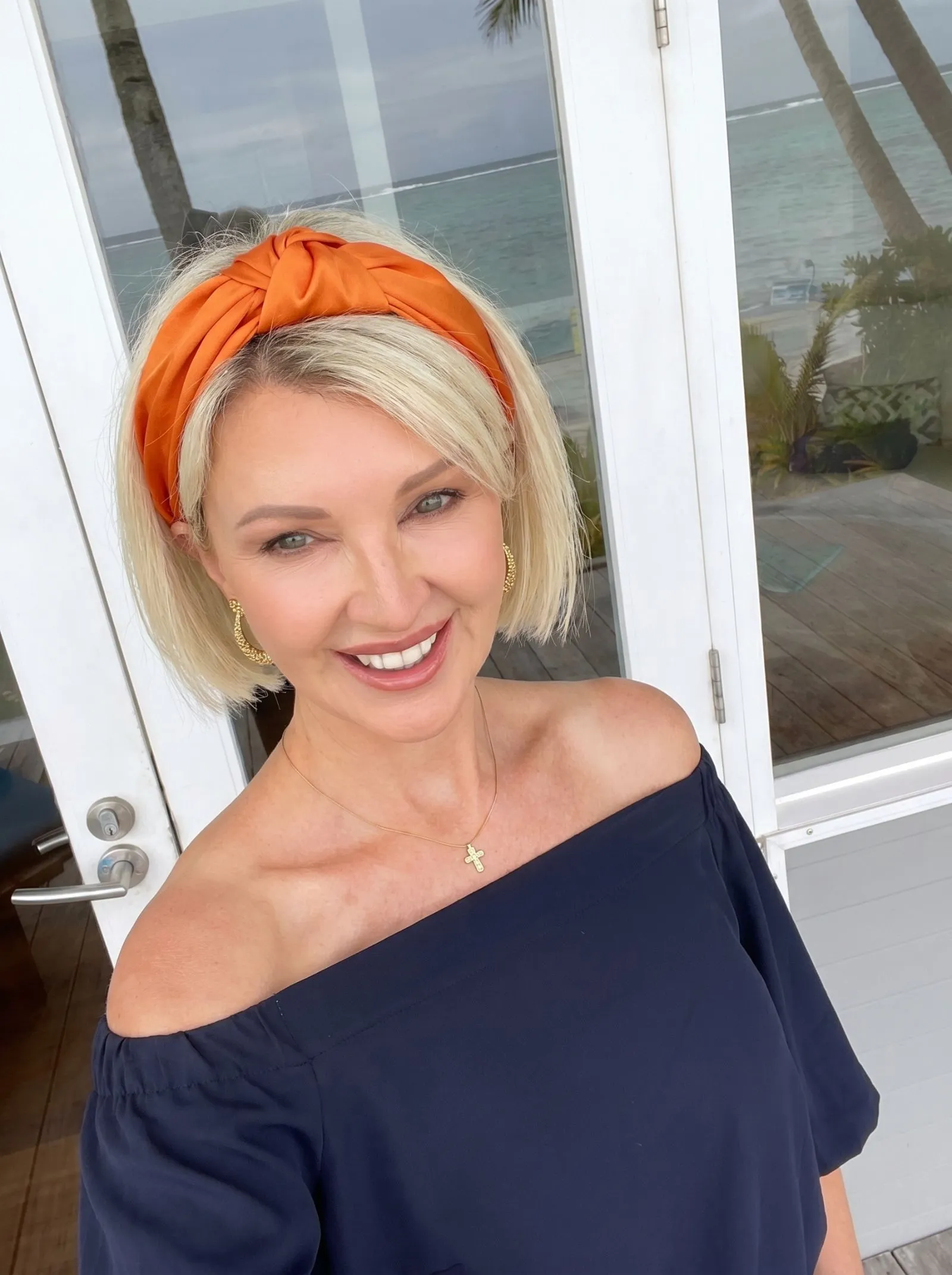 Model with short French bob and orange silk bandana crown fold